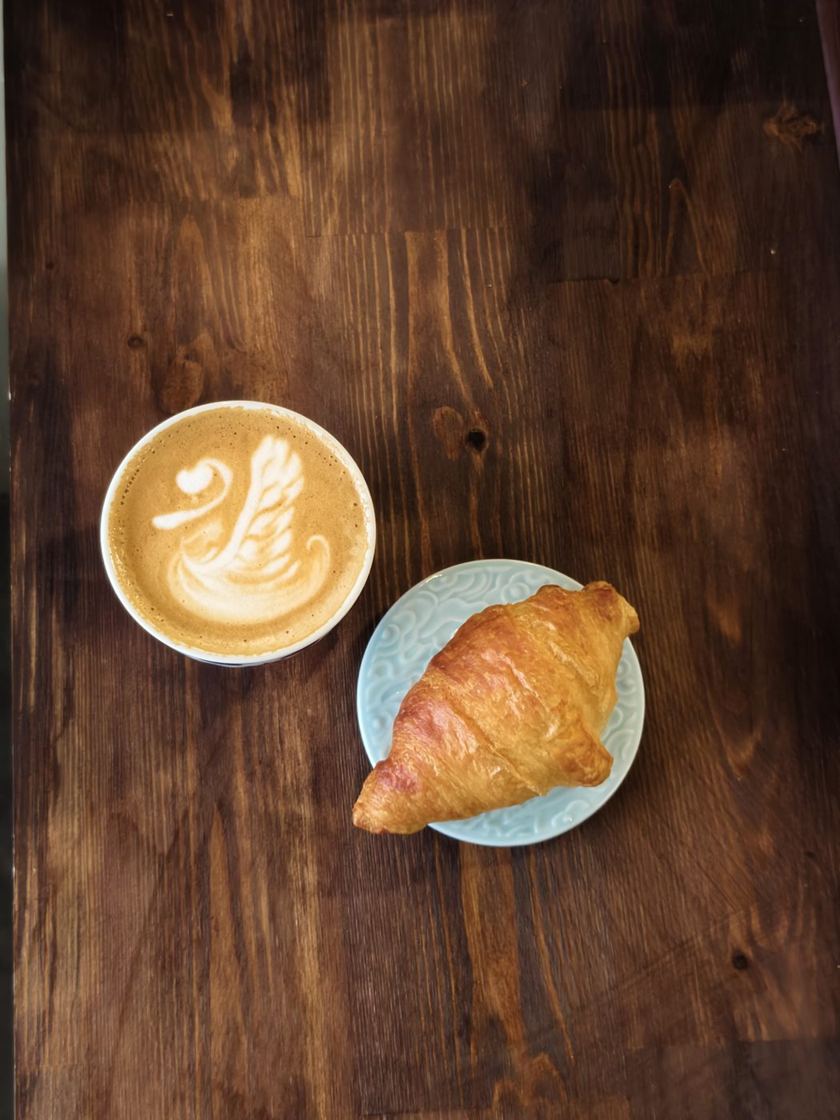 Latte z łabędziem i croissant